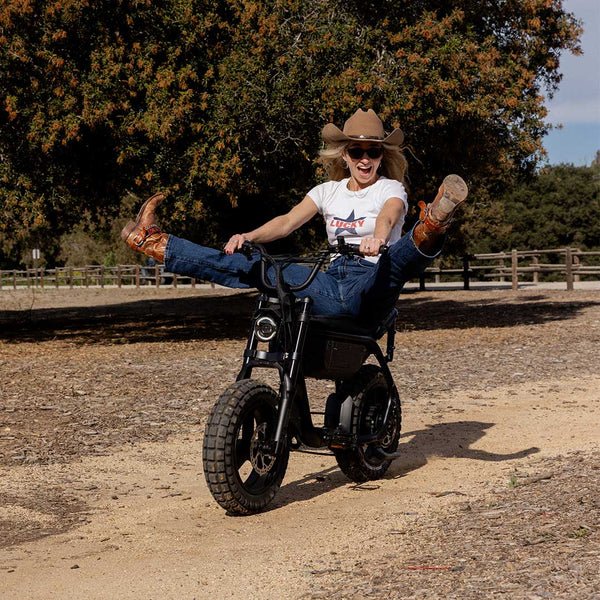 Rider laughing on a sunlit trail